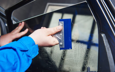 car tinting. Automobile mechanic technician applying foil